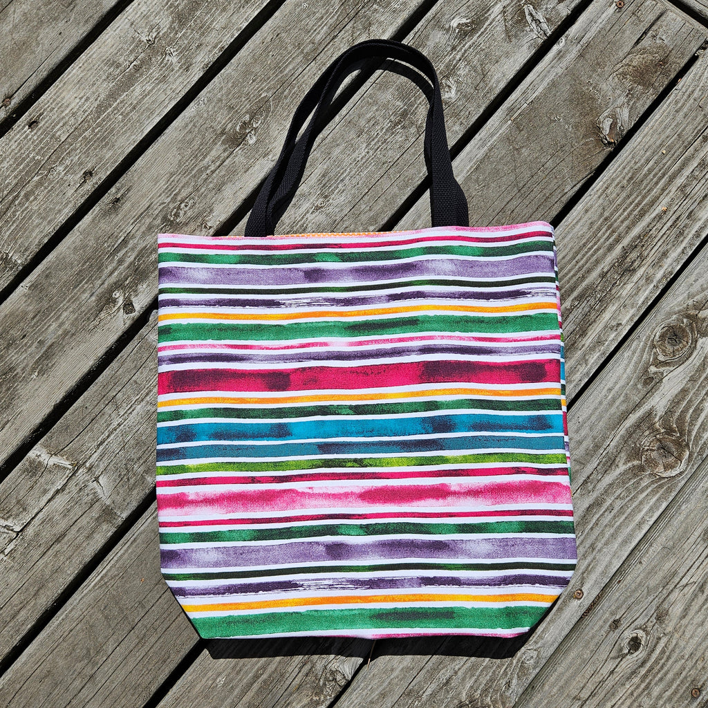 Colorful striped tote bag on a wooden surface