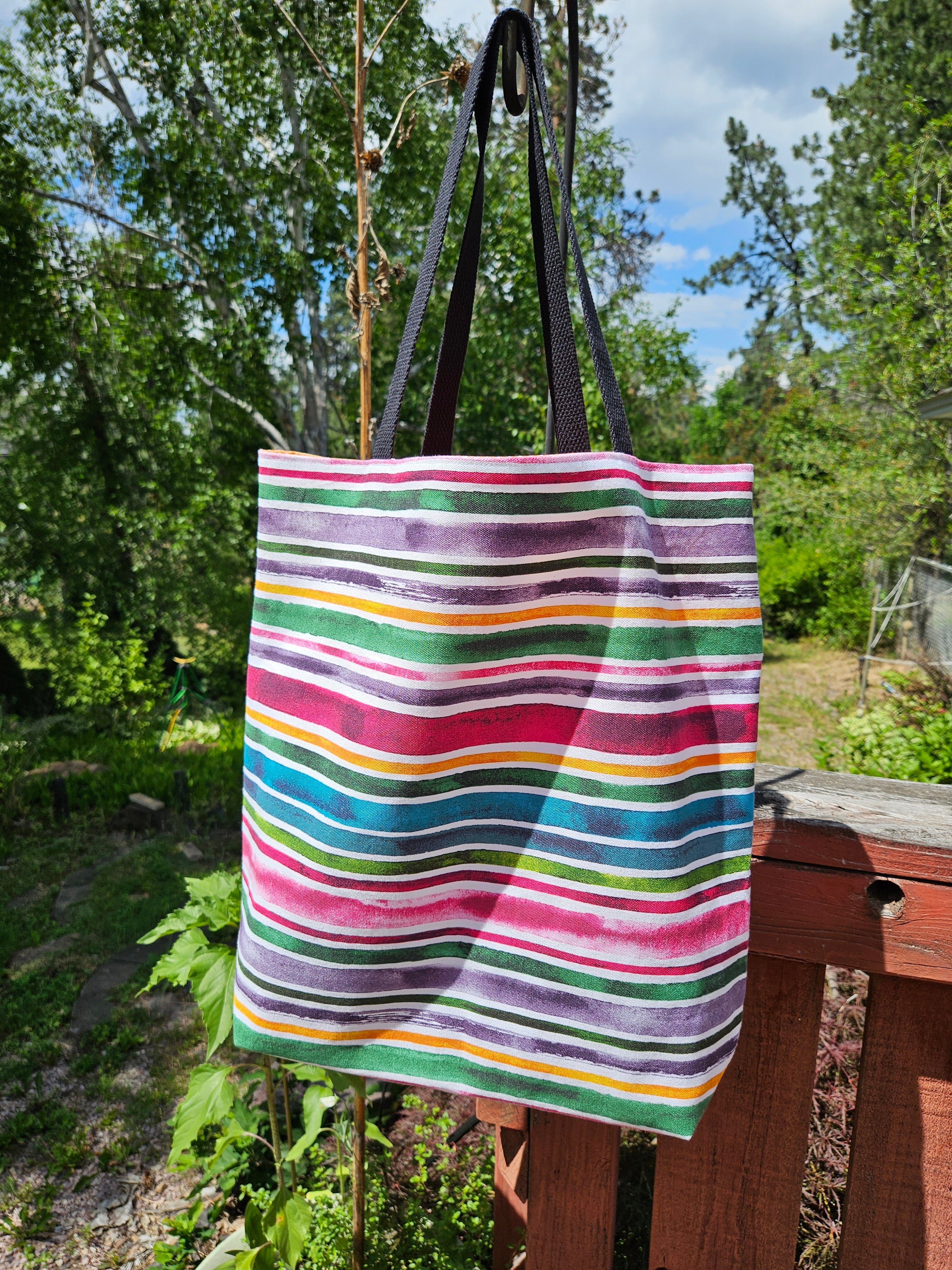 Colorful striped tote bag in a natural setting